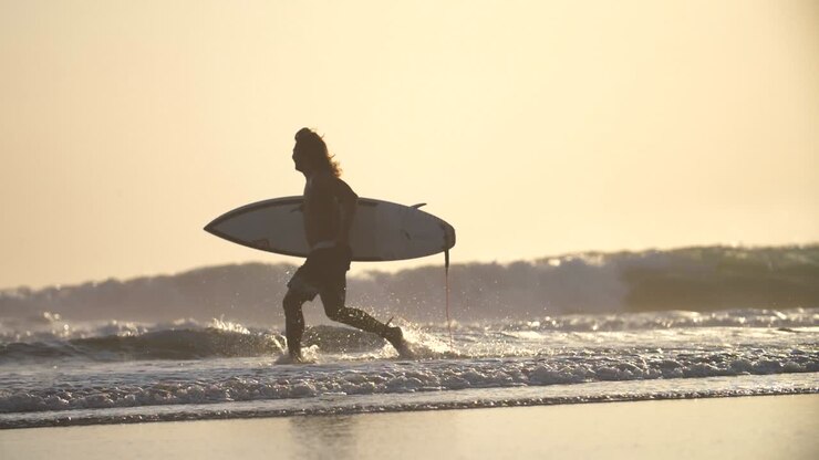 Surfer Running Along a Beach