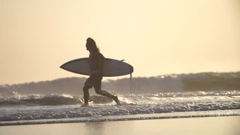 Surfer-Running-Along-a-Beach