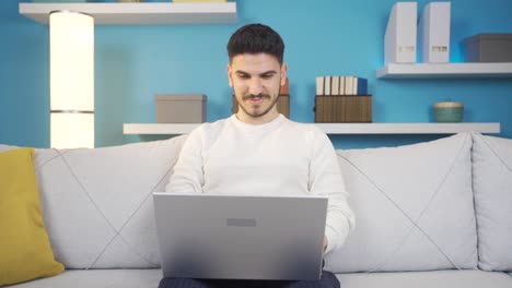 Expression-of-admiration-and-surprise-of-young-man-using-laptop.