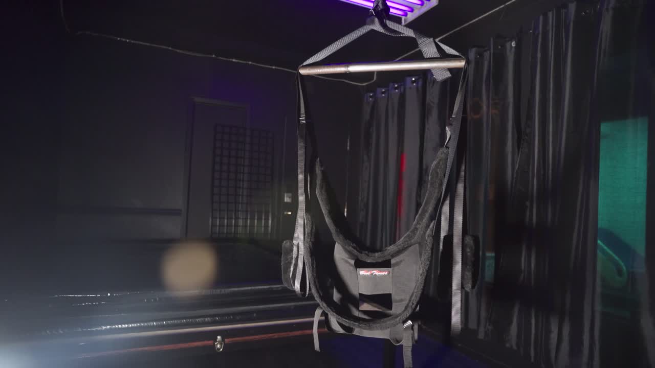 Swing for bondage in a dark room