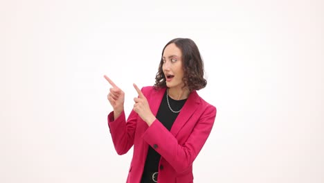 woman in pink blazer pointing and expressing surprise