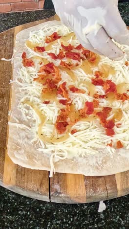 preparing a sandwich with cheese and tomato toppings.