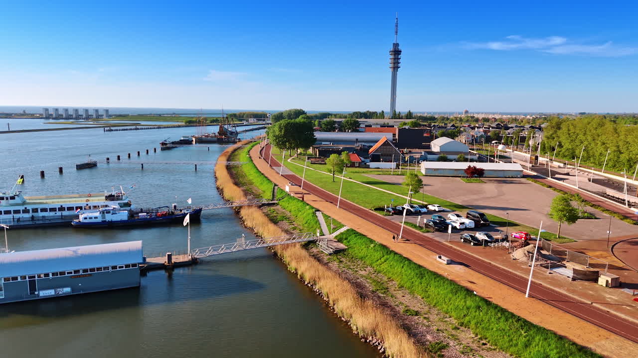 Drone flight near the waterfront of Lelystad, the Netherlands. Telecom tower at backdrop.