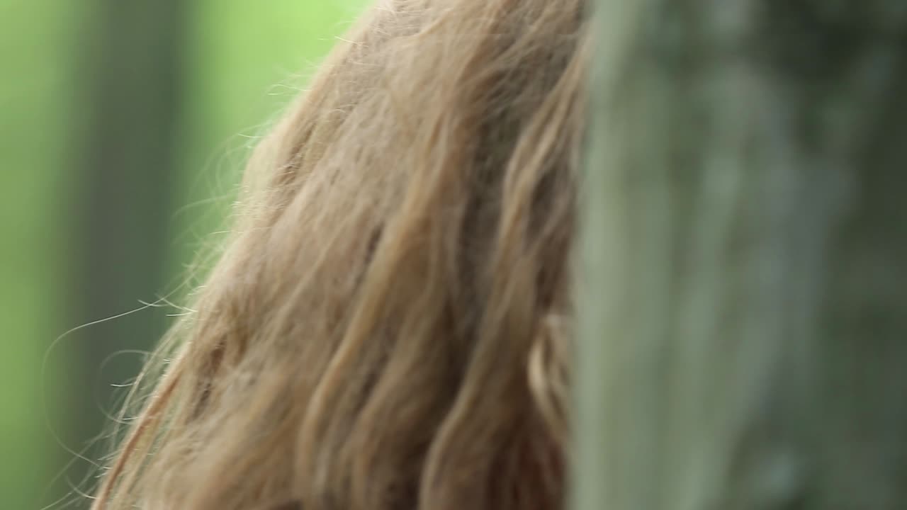 Pretty Woman Walking In The Forest. Pretty woman in a long red dress walking in the forest