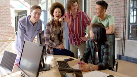 Group-portrait-of-happy-diverse-male-and-female-colleagues-smiling-in-casual-office,-slow-motion