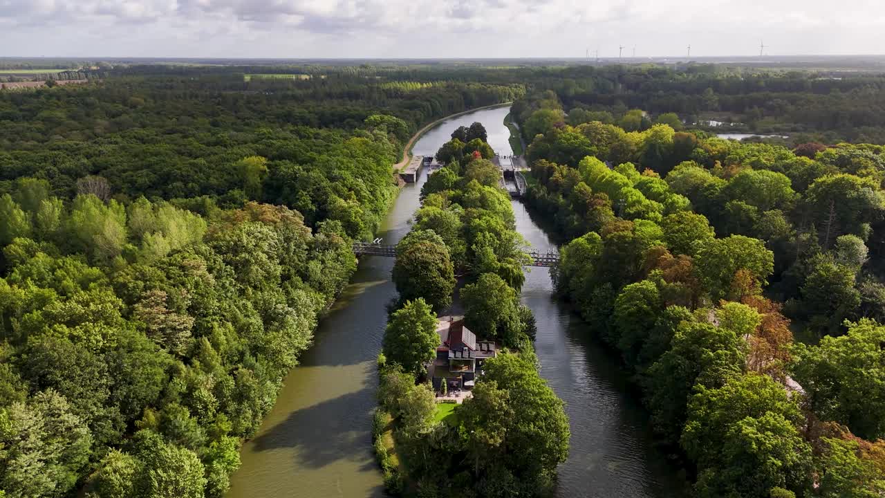 Aerial view of a canal surrounded by trees and forests
