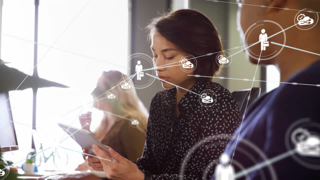 Animation of network of connections with icons over diverse colleagues discussing work in office