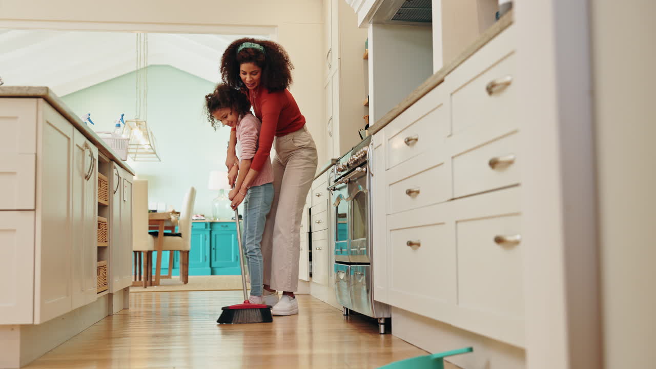 Mother and daughter cleaning the kitchen