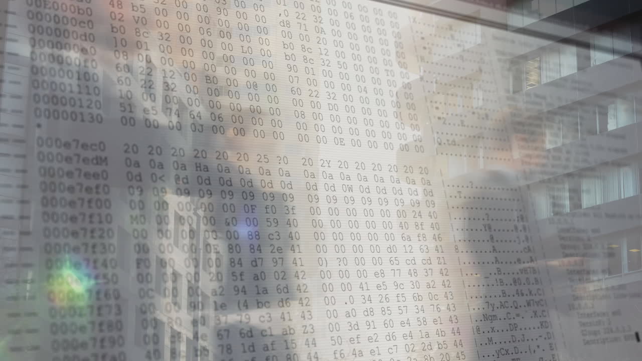 Binary code animation overlaying people working in office building