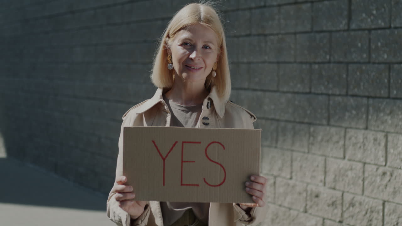 Woman Holding a Sign Saying 'Yes'