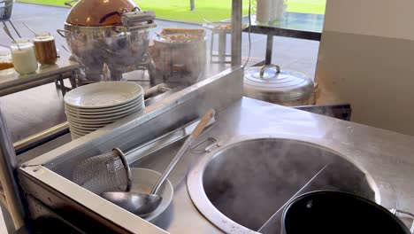 steaming noodles prepared at outdoor food stall