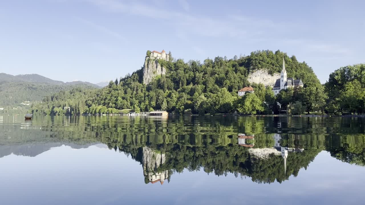 Beautiful reflections on Lake Bled on an early sunny summer morning