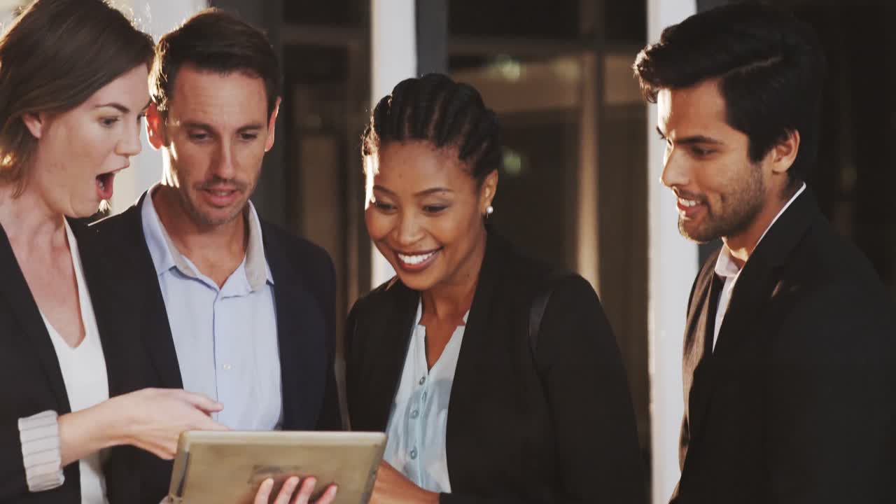 Group of businesspeople discussing together over digital tablet