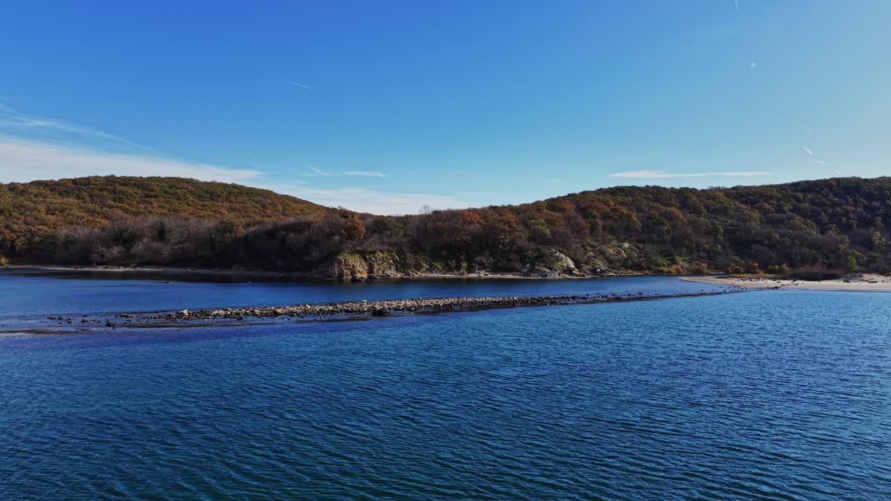 Breathtaking aerial view of a calm coastal landscape with rocky formations