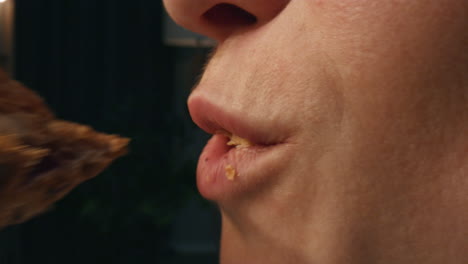 Cute-woman-trying-croissant-at-dark-place-closeup.-Hungry-girl-eating-dessert