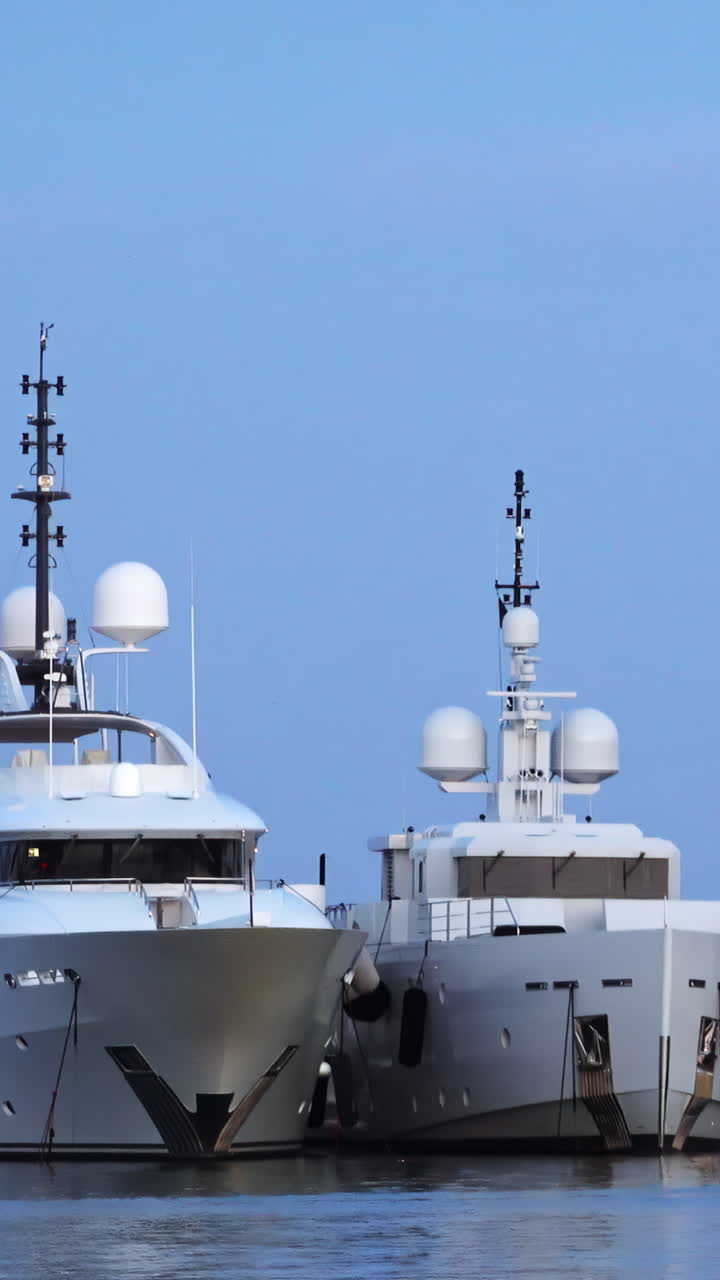 White boats docked in the Port de Cannes in France. Vertical