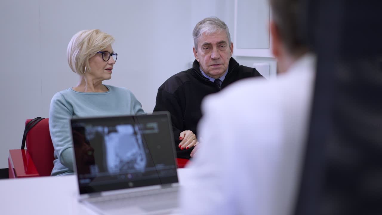 Couple Consulting with Doctor About MRI Scan