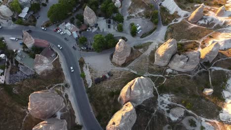 aerial view of cars driving on paved street in old shaped beautiful cappadocia city in turkey