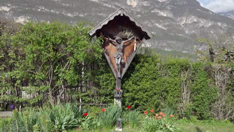 a wooden cross on the side of a street outside the town of kurtinig - cortina, south tyrol, italy