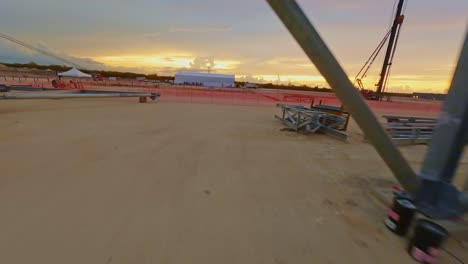 FPV-Drohnenaufnahme-Beim-Flug-Durch-Eine-Baustelle,-An-Einem-Sonnigen-Abend