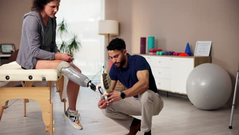 physical therapist assisting patient with prosthetic leg