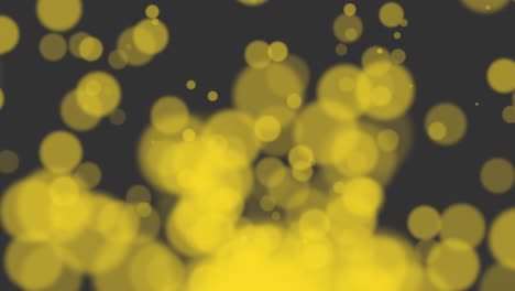 Yellow-glitters-and-particles-on-black-background