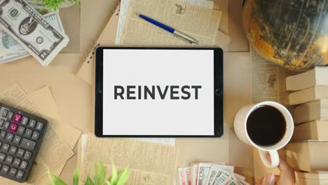 reinvest displaying on finance tablet screen