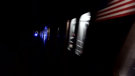 loop of nyc subway moving through dark tunnel.