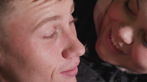 close up of man lost in thought while wife gently gives him peck on cheek showing tender affection emotional connection and love with soft expressions and intimate body language in warm light