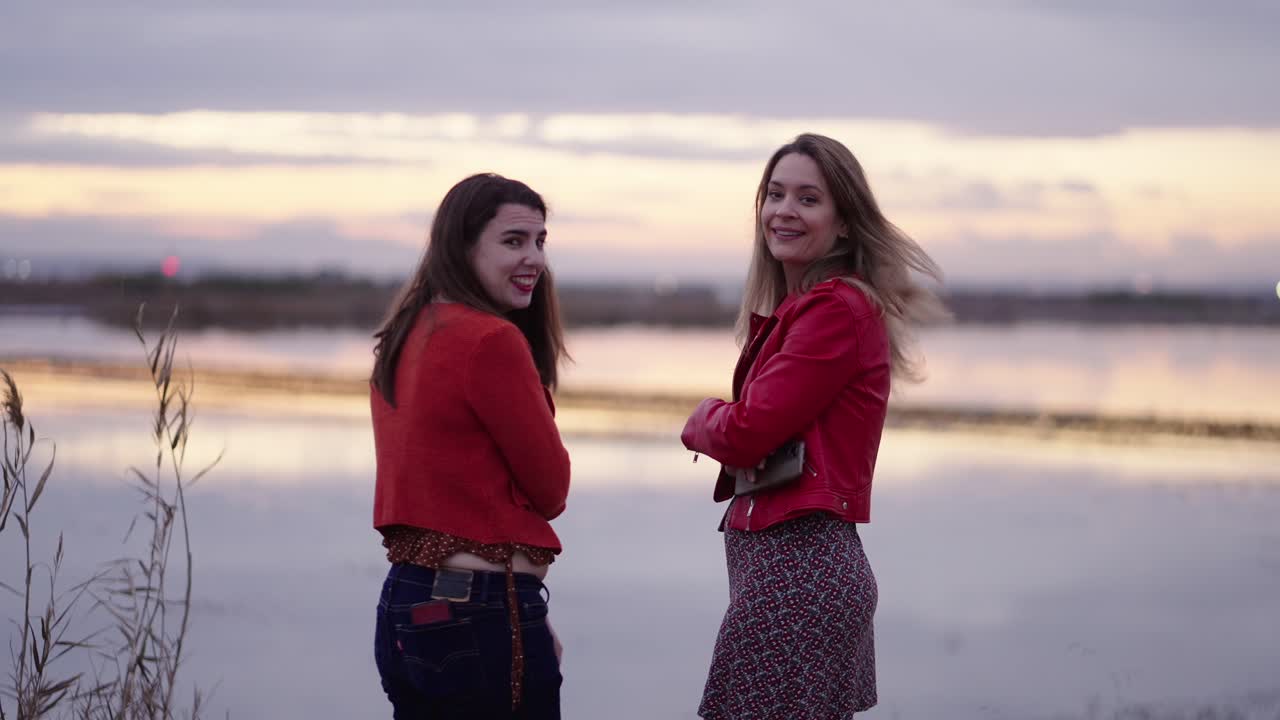 Two Women at Sunset by the Lake