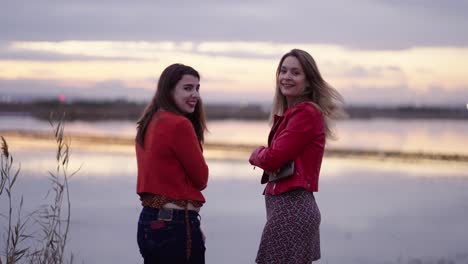 two women at sunset by the lake