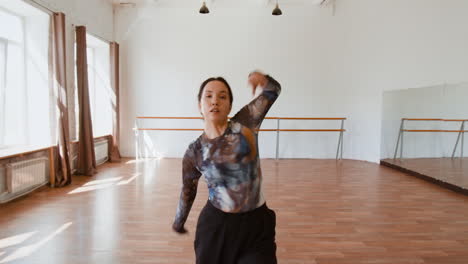 woman practicing contemporary dance in a spacious studio