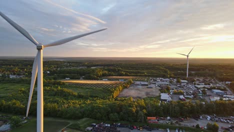 drone shot of windmills generating electricity in rhode island during a sunset