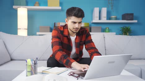 Young-man-working-on-laptop-succeeded.