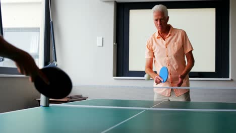 hombre mayor jugando al tenis de mesa