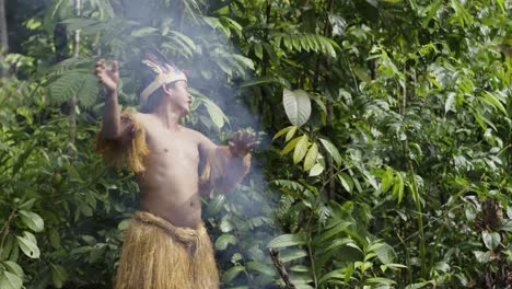An-indigenous-guy-performs-a-ritual-using-smoke-in-the-dense-forest-of-Leticia,-Amazon,-Colombia