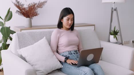 mujer trabajando desde casa en una computadora portátil