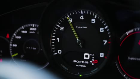 close up shot of the rpm gauge, revving a luxury sport car