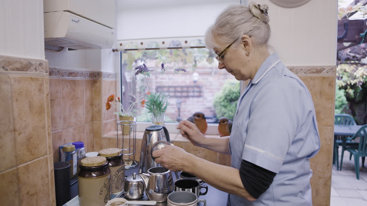 A senior woman preparing tea in the kitchen