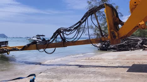 construction equipment at beach dock with boats