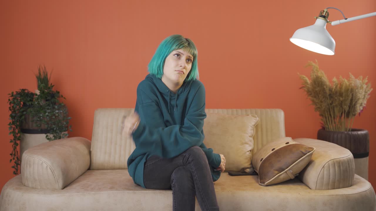 The pessimistic young woman is confused at home.