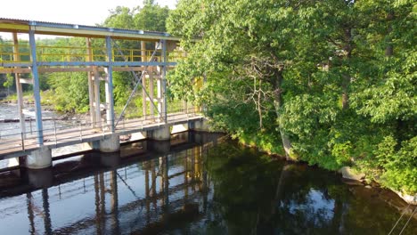 Luftaufnahme-Durch-Eine-Brücke-über-Einen-Fluss,-Der-Durch-Einen-Grünen-Wald-In-Den-Kanadischen-Bergen-Fließt,-Wasdell-Falls,-Ontario