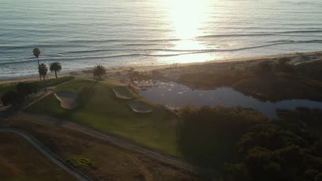 aerial view of the golf course with the oceanside view during sunset