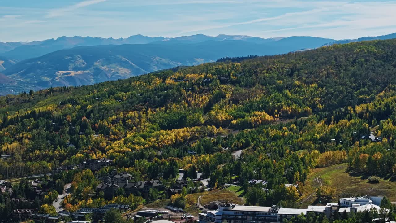 Autumn mountain road and buildings in Snowmass Village, Aspen, Colorado, stunning drone establishing overview