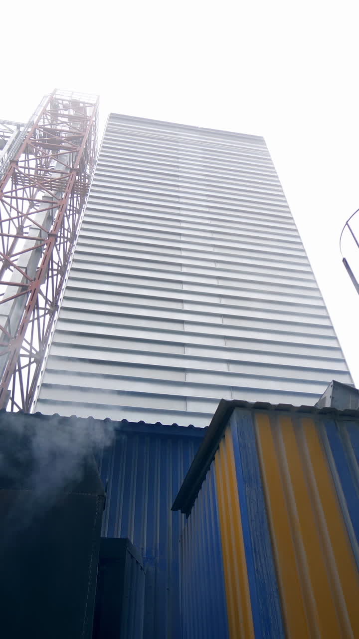 Storage granary technology tank. Big factory elevator construction