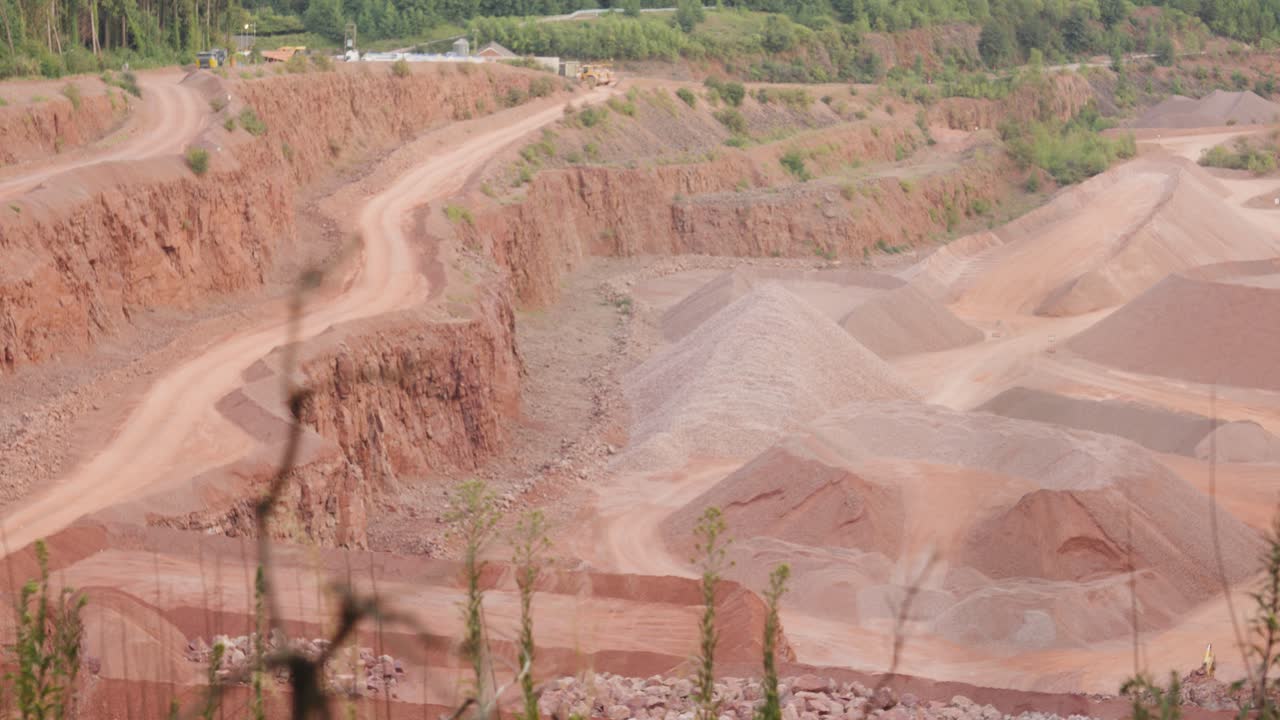 Focus Pull to Reveal Empty Quarry Used for Excavating Natural Resources Like Sand Stone Gravel to Use for Building Materials. Heavy Mining Excavating Industry Surrounded by Natural Environment