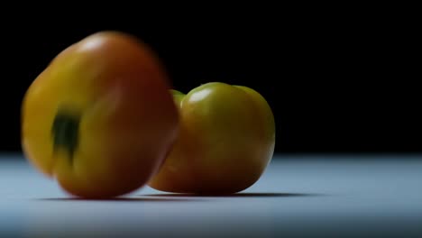 ripe heirloom tomatoes collide and bounce in a studio setting