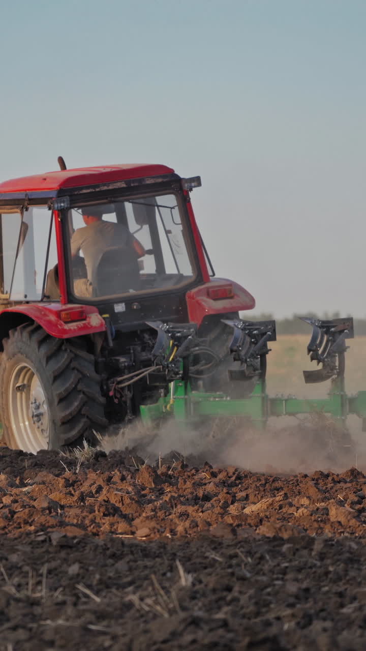 Tractor working in the field. Tractor cultivating and seeding a dry field