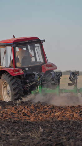 tractor working in the field. tractor cultivating and seeding a dry field