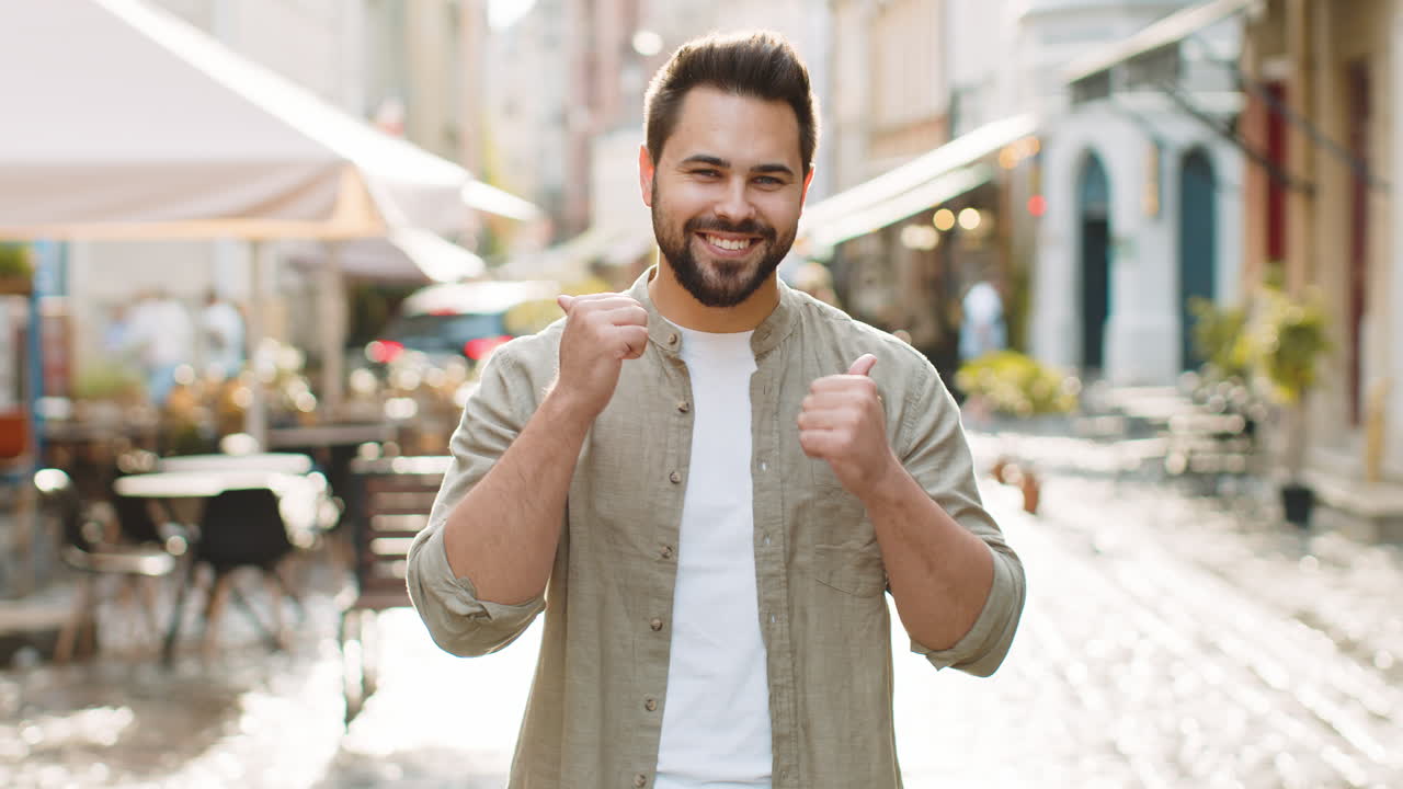Happy man showing thumbs up like sign positive something good positive feedback in city street